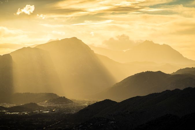Majestic mountain in sunbeams under cloudy sky