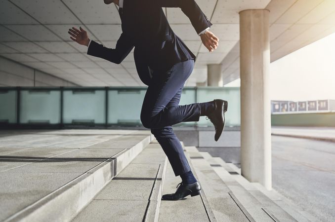 Businessman running fast upstairs