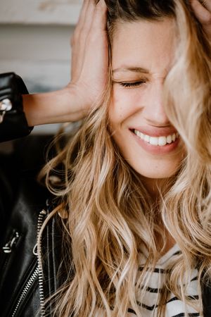 Woman clutching head with closed eyes