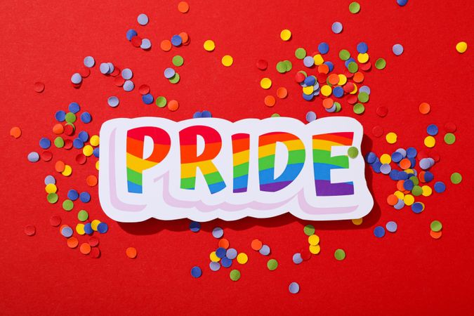 Pride parade concept, colorful symbols on red background.