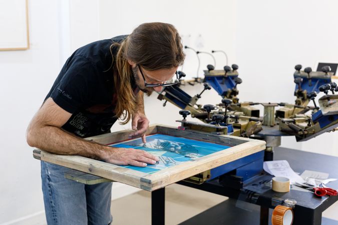 Artist printing screen in workshop