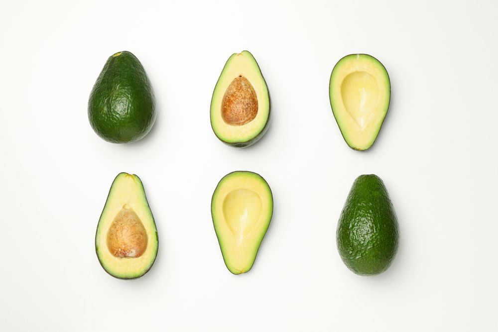 Flat lay with avocado on plain background, top view