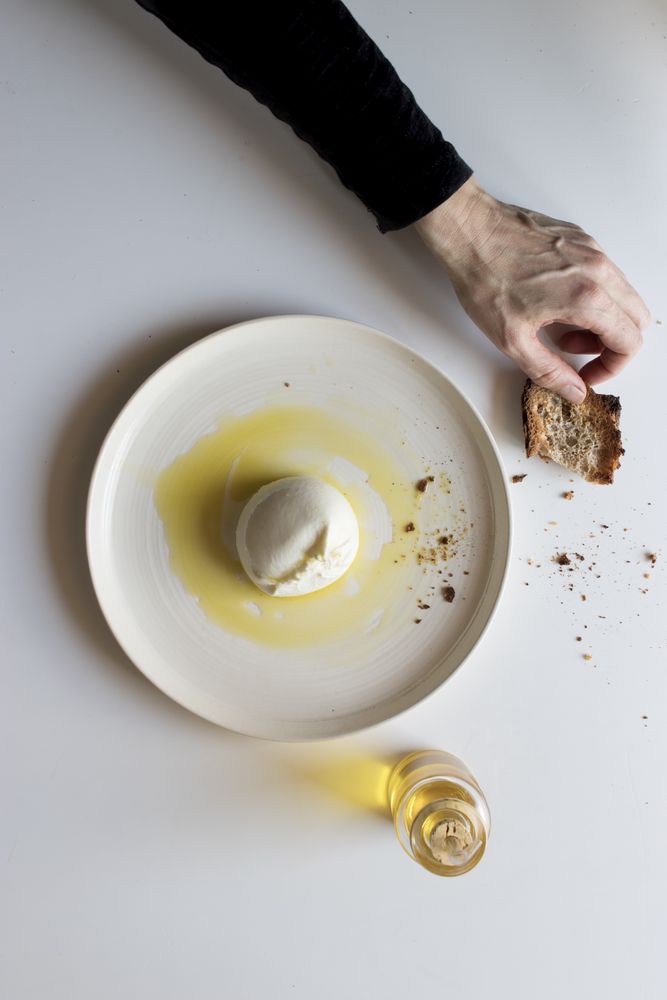 Crop hands with napkin near cheese and condiments