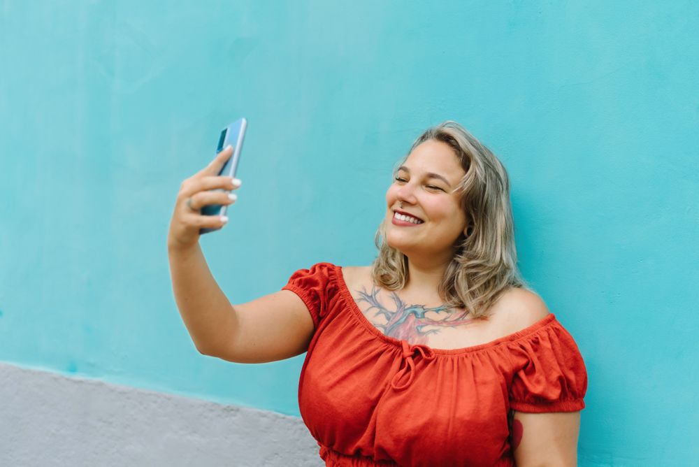 Young woman taking selfie on smartphone