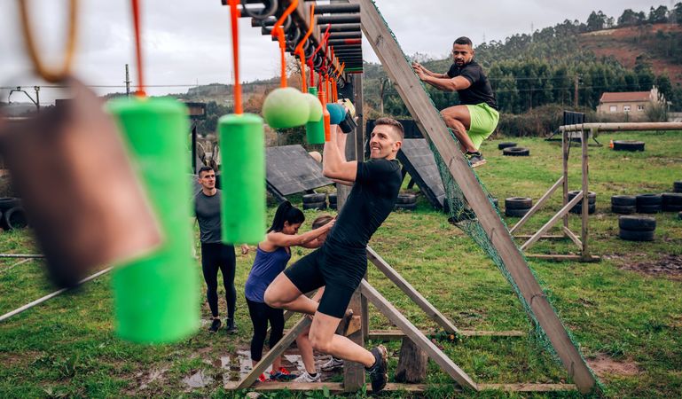 Participant obstacle course doing suspension