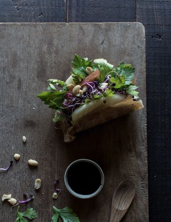 Served Gua Bao sandwich with sauce on board