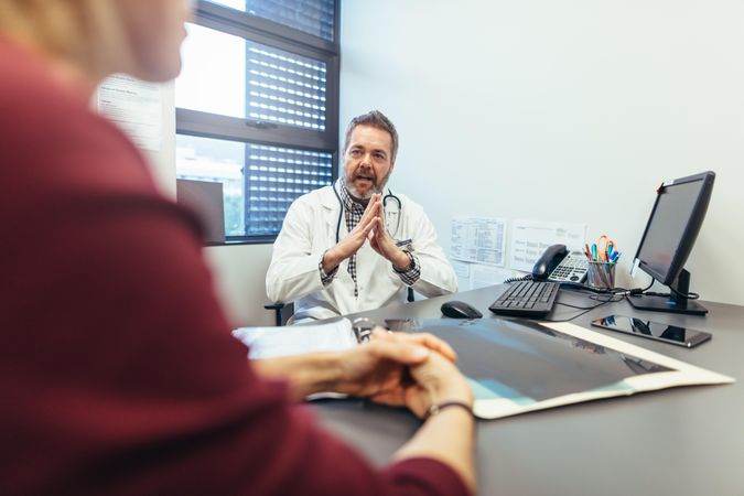 Medicine professional talking with patient in the office