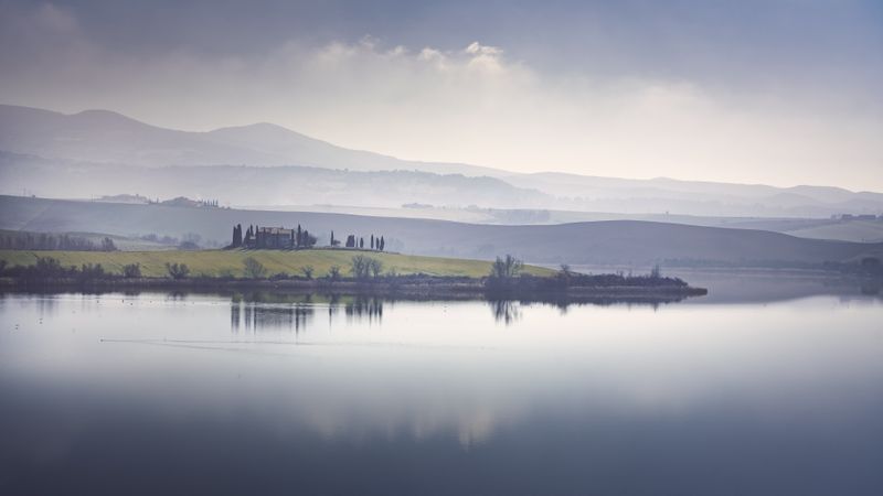 Lake Santa Luce view in a blue misty morning, Tuscany, Italy