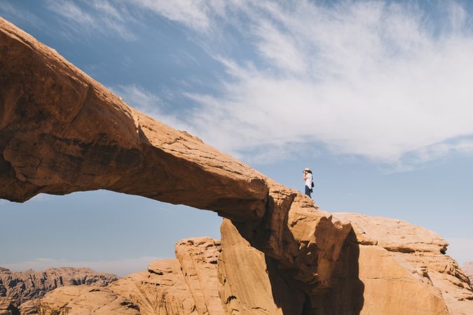 Anonymous photographer on cliff in desert