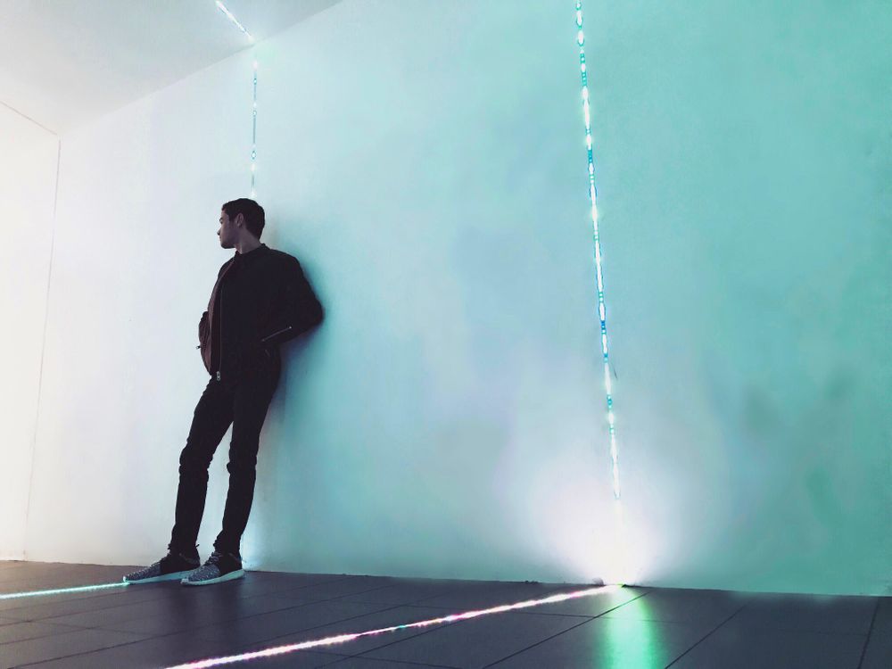 Man in jacket leaning on wall