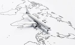 Plane model going over drawn map travel plane