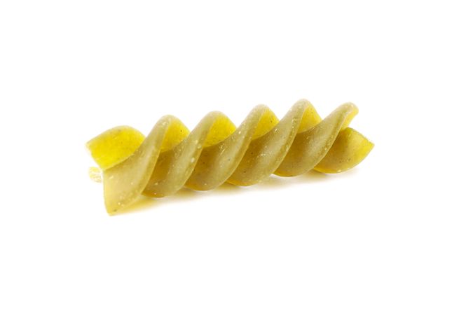 Pasta isolated on light background, closeup. Dry raw whole pasta