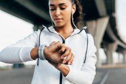Close up of serious woman checking her smartwatch