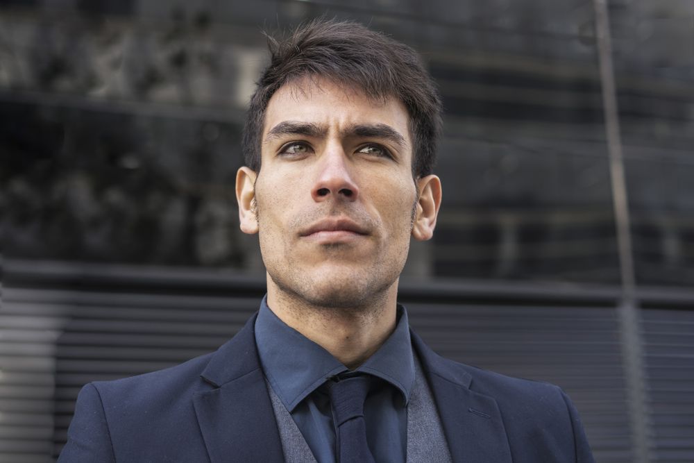Low-angle view of an executive man looking away.