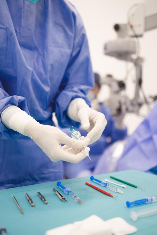 Doctor picking up tools from table in surgery