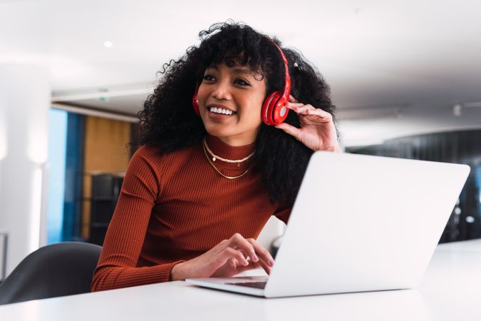 Black female with laptop and headphones