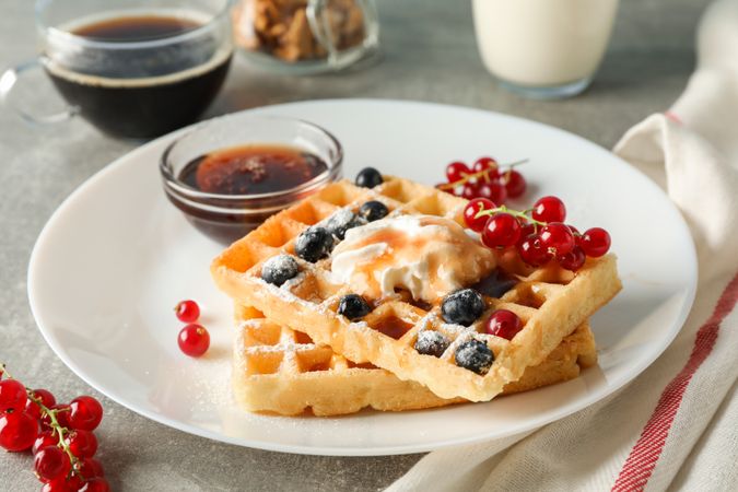 Composition of breakfast with belgian waffles, space for text