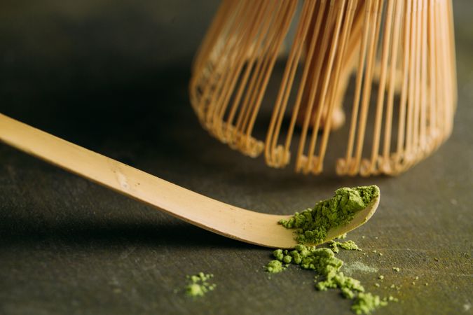 Green matcha tea powder and bamboo whisk
