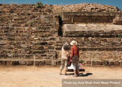 Back of two women looking up at building at Monte Alban, Mexico 5z13m0