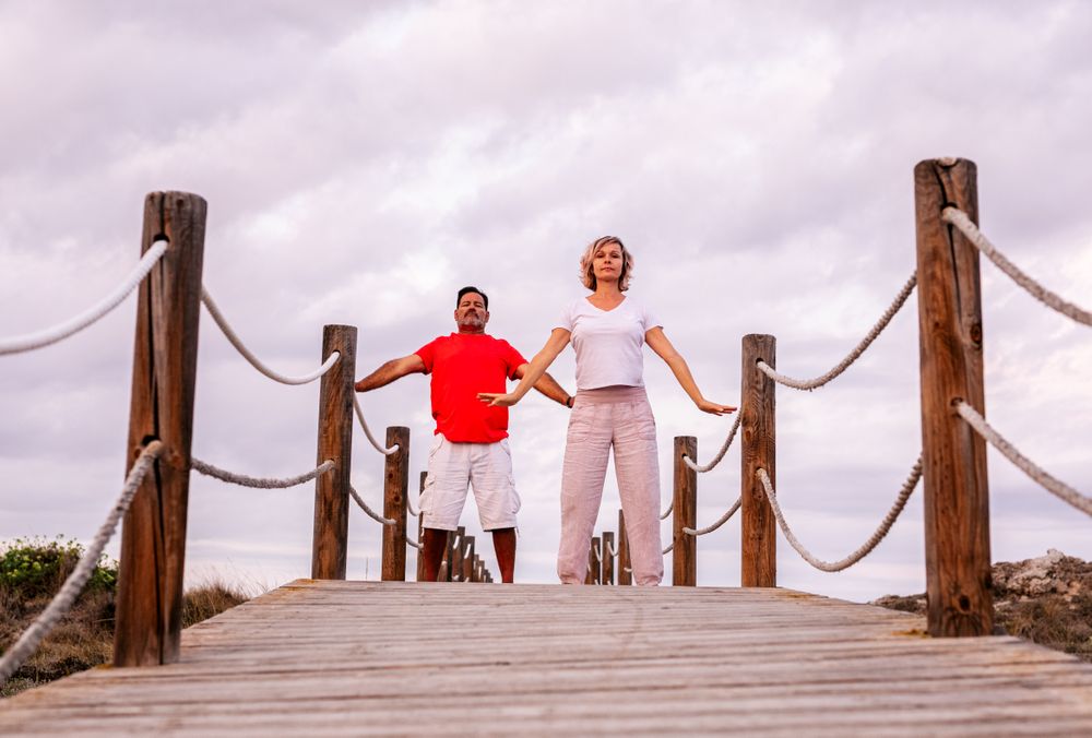 Couple practicing martial arts on lumber path
