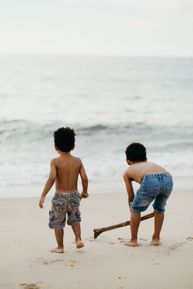 Black boys playing on beach
