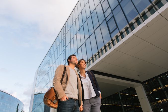 Businesspeople couple outside contemporary building