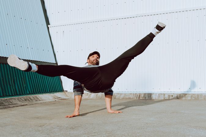 Man performing handstand near wall