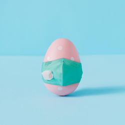 Pastel pink dotted Easter egg wearing face mask