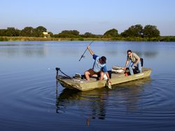 Former U.S. president George W. Bush and an aide fish at the 1,600-acre Crawford Ranch, Texas