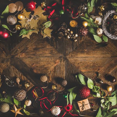 Holiday decorations of stars, baubles, leaves, and ribbon, square crop, with copy space