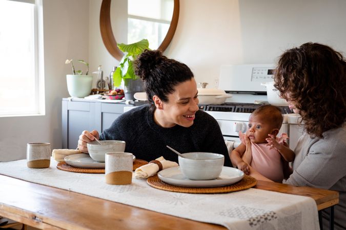 Happy women with baby at their dining table