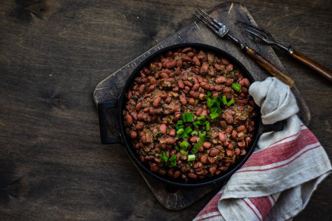 Top view of traditional Georgian lobio dish in cast iron pan on with kitchen towel