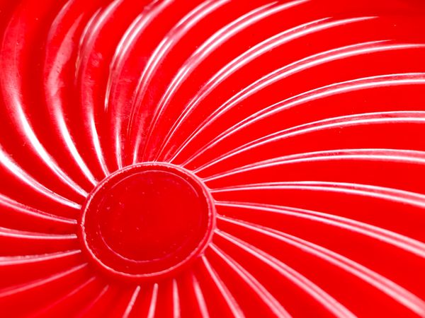 Red glossy abstract background with swirl texture