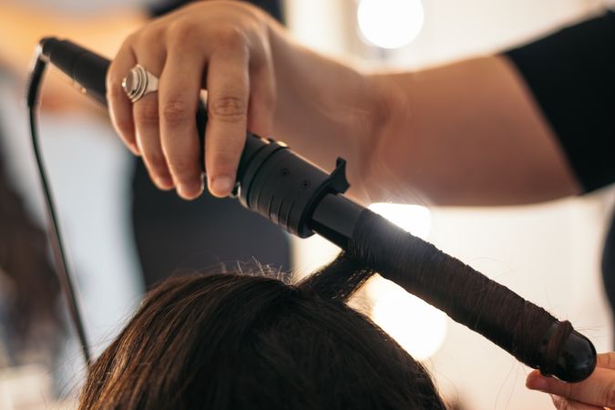 Close-up of a hair curler with which someone is making waves