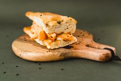 Flat bread sandwich on wooden cutting board