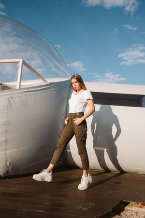 Stylish female standing near bubble hotel