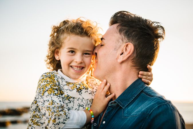 Father with her daughter at beach