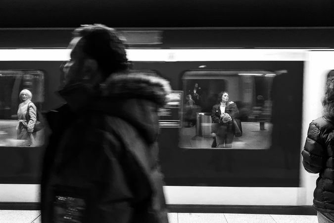 Grayscale photo of people at the subway