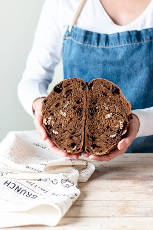 Hands of woman holding rye bread