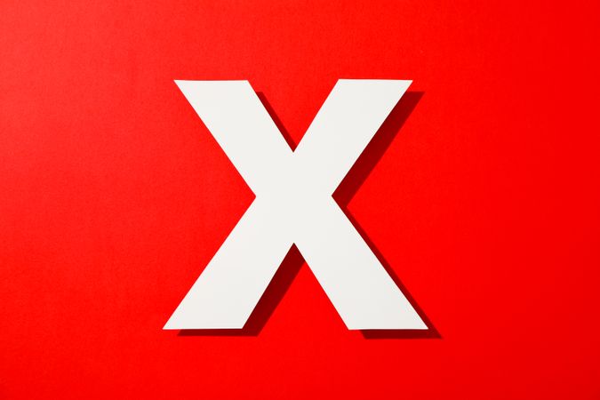 Paper letter X on color background, space for text