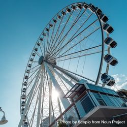 Worm view of Ferris wheel under blue sky in Miami, Florida, United States  5QdQe0