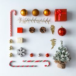 Christmas layout made of festive decorations, baubles, candy canes, presents on light background