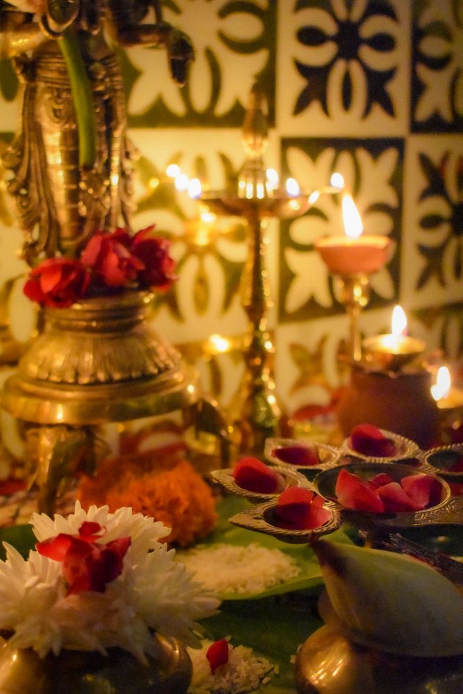 Table of lit diya and flowers