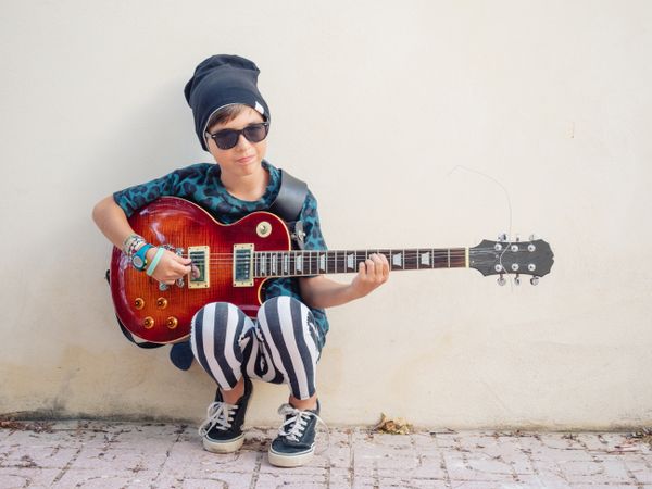 Energetic kid holding guitar