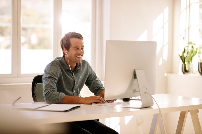Happy professional male using computer for video call