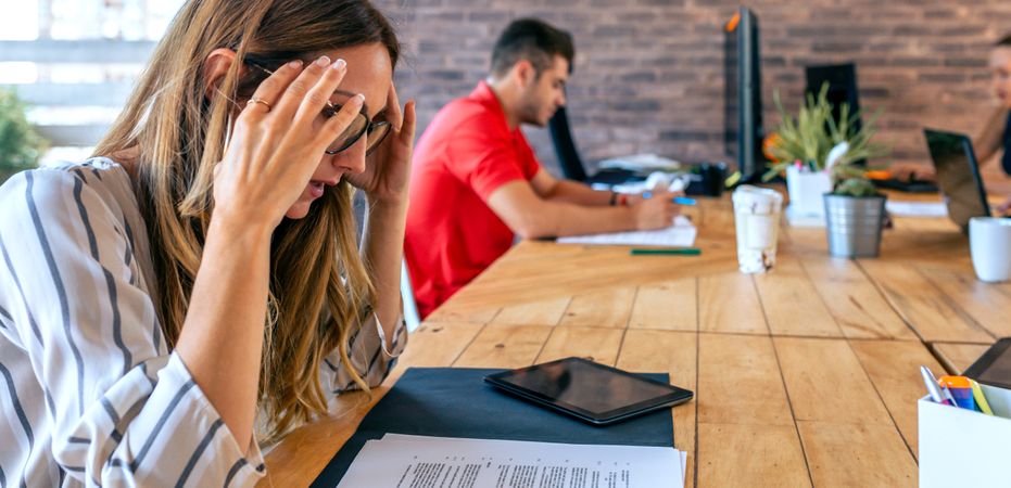 Stressed businesswoman with hands on head