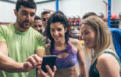 Athletes looking at the mobile of a gym mate