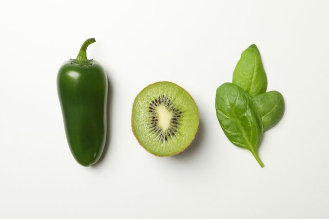 Kiwi, spinach and pepper on blank background