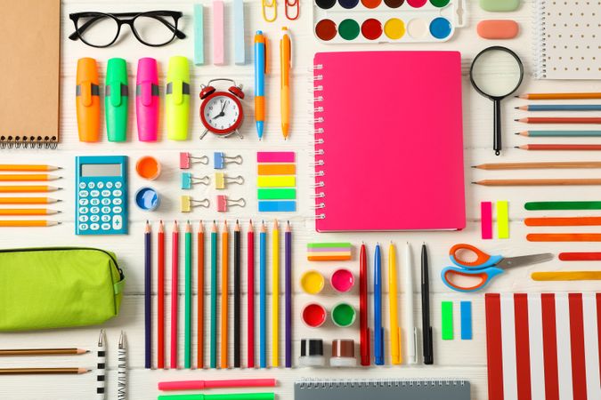Flat lay composition with school supplies on wooden background