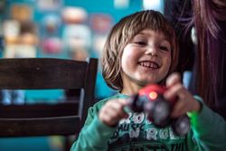 Boy holding a toy smiling